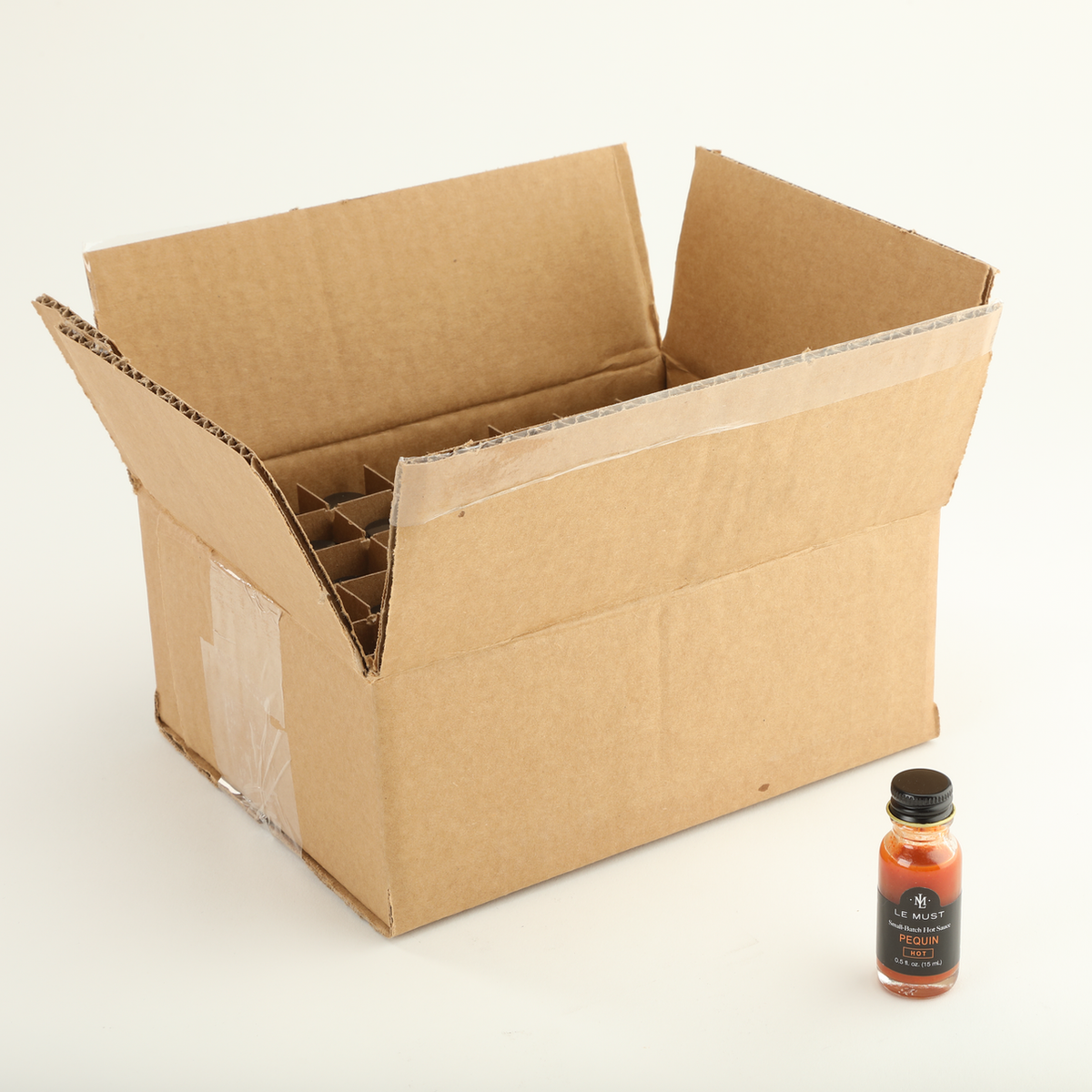 Le Must Pequin Hot Sauce, 15 ml, with its carton
