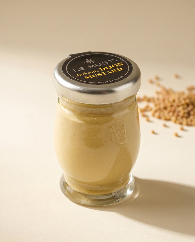 Le Must Deluxe Organic Dijon Mustard, 48 grams, on a white tablecloth