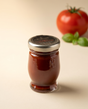 Le Must Deluxe Natural Ketchup, 55 grams, on a set table