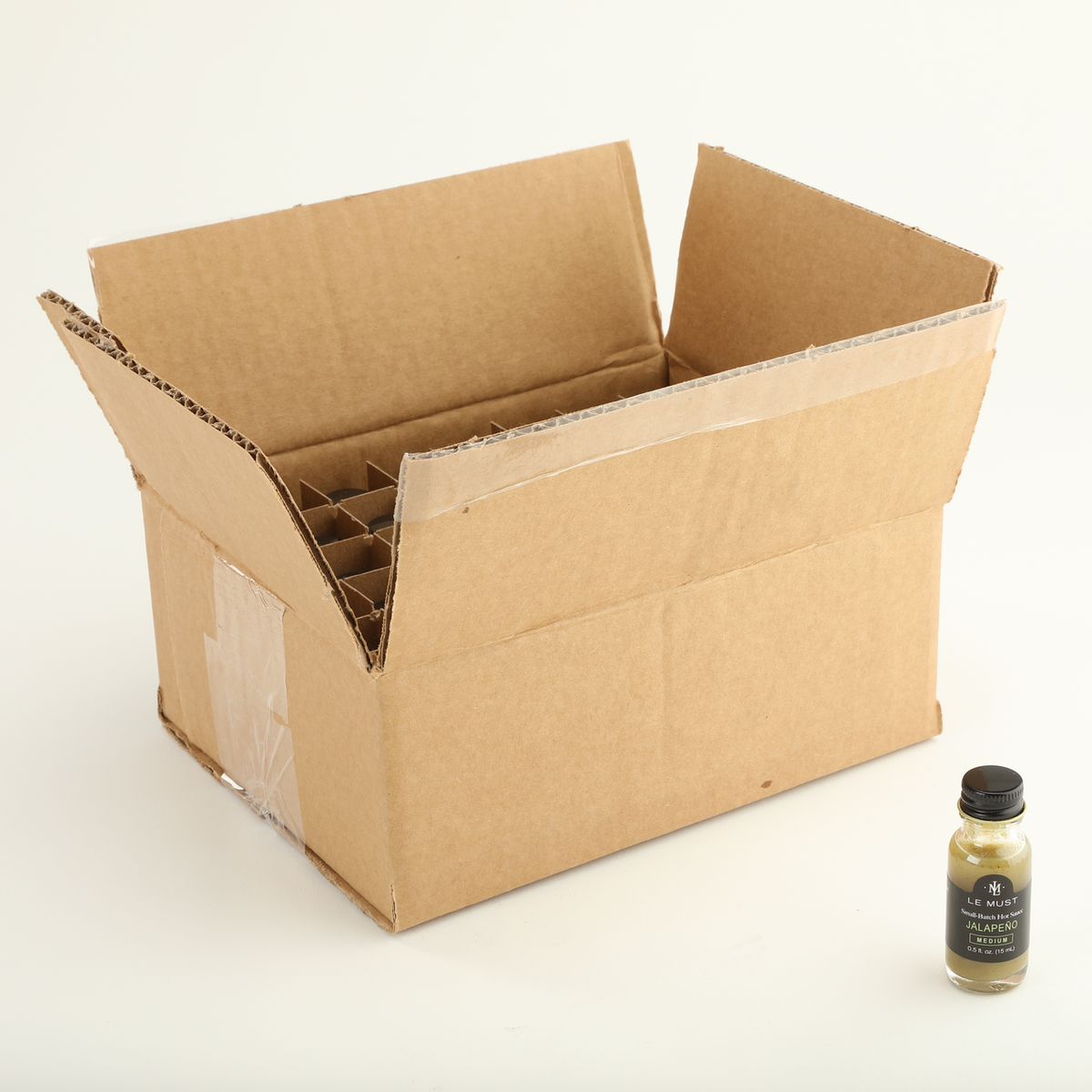 Le Must Jalapeño Hot Sauce, 15 ml, with its carton