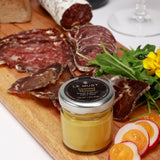 Le Must Premium Organic Dijon Mustard, 33 grams, on a charcuterie board